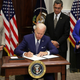 President Joe Biden signs an executive order on access to reproductive health care services as (L-R) Vice President Kamala Harris, Secretary of Health and Human Services Xavier Becerra, and Deputy Attorney General Lisa Monaco look on during an event at the Roosevelt Room of the White House on July 8, 2022, in Washington, DC.